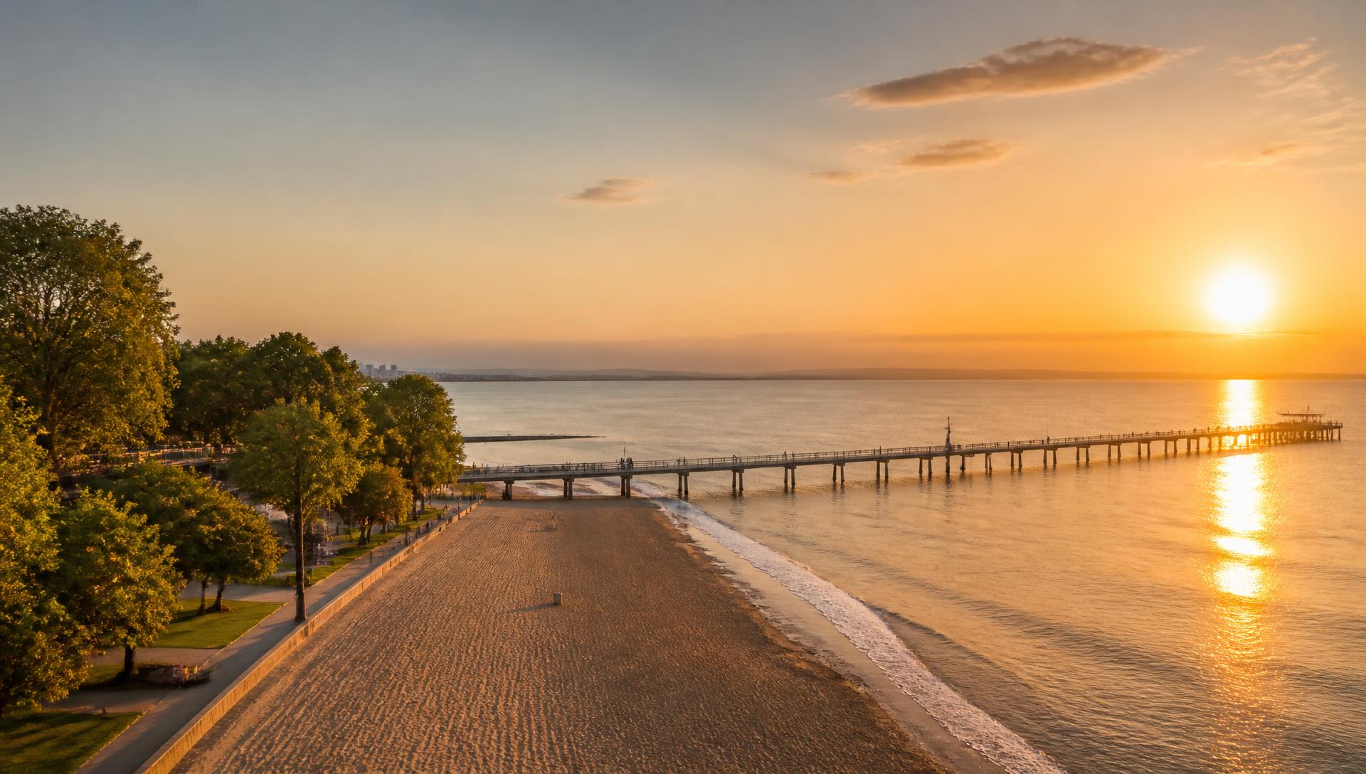 Sunset over the wooden bridge, beach and Sea Garden in Burgas, Bulgaria